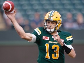 Edmonton Eskimos quarterback Mike Reilly (13) makes the throw against the Hamilton Tiger-Cats during first half CFL action in Edmonton, Alta., on Friday August 4, 2017.