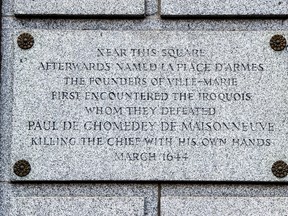 A plaque is seen on the Bank of Montreal building, Thursday, August 3, 2017 in Montreal. Michael Rice, a Mohawk man, wants the Bank of Montreal and the City of Montreal to address a plaque attached to the bank's headquarters downtown that was written in honour of Paul de Chomedey, sieur de Maisonneuve, the founder of Montreal as the plaque is historically inaccurate. THE CANADIAN PRESS/Paul Chiasson