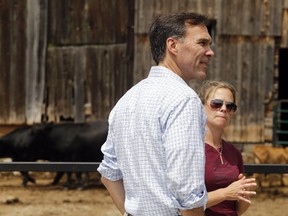 Federal finance minister Bill Morneau tours the Enright Cattle Co. farm with co-owner Kara Enright Wednesday, July 19, 2017 in Tweed, Ont. (Luke Hendry/Belleville Intelligencer/Postmedia Network)