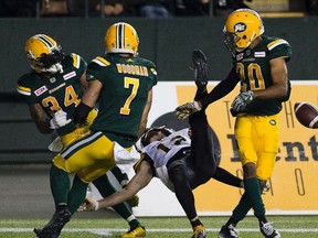 Edmonton Eskimos Garry Peters (34) Josh Woodman (7) and Johnny Adams (20) stop a final attempt by the Hamilton Tiger-Cats Mike Jones (12) to win the game on Friday August 4, 2017, in Edmonton.