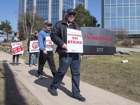 Striking journalists walk outside the Chronicle Herald building in Halifax on Thursday, April 13, 2017. THE CANADIAN PRESS/Andrew Vaughan