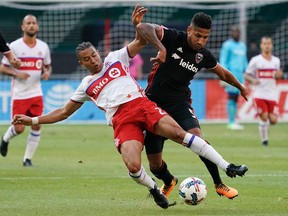 Toronto FC's Justin Morrow is upended by D.C. United defender Sean Franklin during Saturday night's game. (AP)