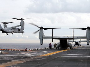 In this June 29, 2017 file photo U.S. Marine MV-22B Osprey aircraft land on the deck of the USS Bonhomme Richard amphibious assault ship off the coast from Sydney during events marking the start of Talisman Saber 2017, a biennial joint military exercise between the United States and Australia. (Jason Reed/Pool Photo via AP, File)