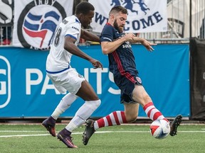 FC Edmonton striker Tomi Ameobi, left, battles Indy Eleven defender Colin Falvey in North American Soccer League play at Michael A. Carroll Stadium in Indianapolis, Indiana on Saturday Aug. 5, 2017.