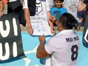 Toronto Wolfpack forward Fuifui Moimoi signs autographs at Lamport Stadium, in Toronto on Saturday, July 15, 2017. (THE CANADIAN PRESS/Neil Davidson)