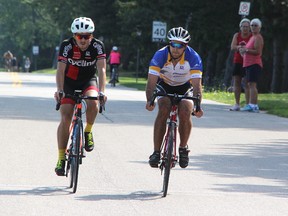 Joel Vosburg, left, and David Coate race along Old Lakeshore Road in Bright's Grove Sunday, during the second annual Bluewater International Granfondo. More than 700 cyclists took part, organizers said. Tyler Kula/Sarnia Observer/Postmedia Network