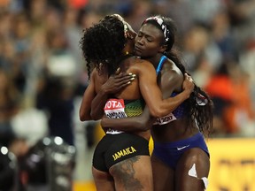 United States' Tori Bowie, right, hugs Jamaica's Elaine Thompson after winning the Women's 100 meters final during the World Athletics Championships in London Sunday, Aug. 6, 2017. (AP Photo/Tim Ireland)