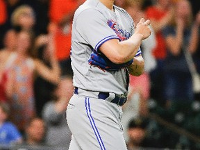 Toronto Blue Jays relief pitcher Roberto Osuna walks to the mound after Houston Astros designated hitter Carlos Beltran scored a game-tying run on Alex Bregman's two-run triple during the ninth inning of a baseball game, Sunday, Aug. 6, 2017, in Houston. (AP Photo/Eric Christian Smith)