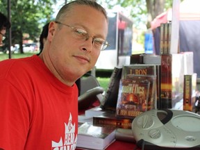 Travis Desmeules displays an e-meter at the Dianetics  booth run by Scientologists from Cambridge at London?s Ribfest. (CHARLIE PINKERTON/The London Free Press)