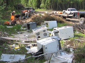 Cleaning up illegal dump site near Grande Prairie | Photo courtesy of Alberta Parks