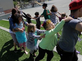 In this Tuesday, July 11, 2017 photo, campers and camp counselors dance at the Bay Area Rainbow Day Camp in El Cerrito, Calif. (AP Photo/Jeff Chiu)