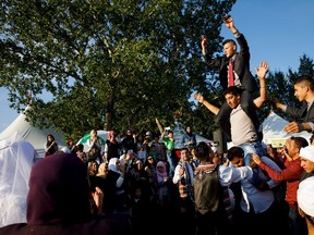 The groom is lifted during the wedding of Mostafa Khalis and Manar Shakeouf at the Syrian Pavilion at the Heritage Festival in Edmonton on Saturday, Aug. 5, 2017.