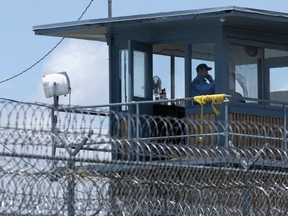 In this photo taken May 13, 2011 file photo, a guard is shown in a tower at the Arkansas Department of Correction Tucker Unit near Tucker, Ark. (AP Photo/Danny Johnston, File)