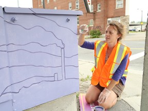 Local artist Julieanne Steedman paints a hydro box last week. A number of these typically bland fixtures are being transformed into art as part of the Up Here festival on Aug. 18-20. (John Lappa/Sudbury Star)