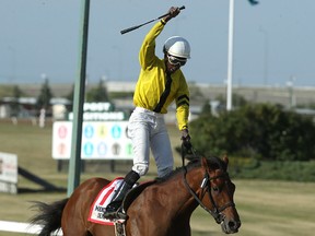 Tyrone Nelson celebrates atop Plentiful after winning the Manitoba Derby at Assiniboia Downs in Winnipeg on Aug. 7, 2017. (Kevin King/Winnipeg Sun/Postmedia Network)