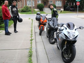 Jamie Leslie and Ken Pucula talk with other motorcyclists that arrived at the scene of an overnight fatal crash on Ridout Street S in London, Ont. on Monday July 17, 2017. Jake Timmerman, 17 died after an early Sunday morning collision, after he struck a utility pole near Bruce Street. Leslie is a proponent of a European graduated licensing system where young riders are limited to the size of bikes they can legally ride. Experience in the Timmerman case doesn't seem to be the issue as the young man was an experienced motorcross rider and was highly regarded as a good rider by other motorcyclists. Mike Hensen/The London Free Press/Postmedia Network
