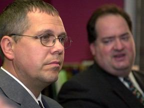 This Sept. 8, 2005, file photo shows Customs and Border Protection Officer Robert Rhodes listening to his defense attorney, Steven Cohen, during a press conference after the verdict from the U.S. Federal Courthouse in Buffalo, N.Y.
 (AP Photo/Don Heupel)