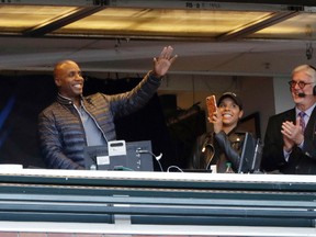 Former San Francisco Giants player Barry Bonds, left, waves to fans from the broadcast booth next to Mike Krukow, right, during a game against the Chicago Cubs, Monday, Aug. 7, 2017, in San Francisco. (AP Photo/Marcio Jose Sanchez)