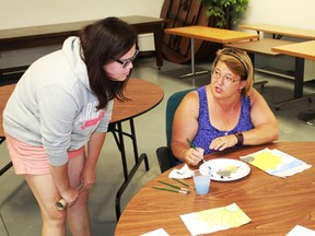 Sherry Greipentrog and Jana Rejcha discuss the finer points of creating the perfect flower during the Brain Injury Association of Sarnia-Lambton's expressive art workshop on Aug. 2.
CARL HNATYSHYN/SARNIA THIS WEEK