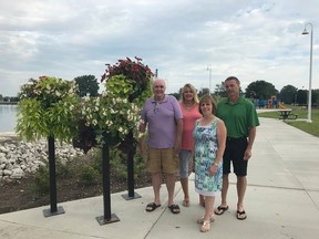 Communities in Bloom's Al Duffy, the City of Sarnia's Patti Ross, Sarnia councillor and chair of Communities in Bloom Anne Marie Gillis and St. Patrick's teacher Matt Abbott stand beside a set of new planters in Centennial Park, the result of a partnership between St. Patrick's High School, Communities in Bloom and the city. 
Handout/Sarnia This Week