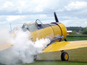 Bill Long, 81, celebrated his final Harvard landing with smoke oil on the exhaust and, once out of the cockpit, a shot of single malt Scotch. HEATHER RIVERS/WOODSTOCK SENTINEL-REVIEW