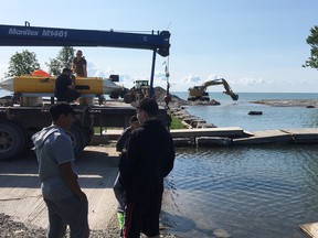 SUBMITTED PHOTO 
An excavator re-digs the exit from the Quinte’s Isle Park marina, after high winds stirred the bottom of the Lake Ontario, blocking the sonars ability to exit the marina.