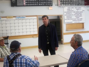 Agriculture and Forestry Minister and Whitecourt-Ste. Anne MLA Oneil Carlier listens to seniors’ concerns prior to speaking at Whitecourt’s seniors circle on Aug. 3 (Jeremy Appel | Whitecourt Star).