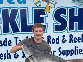 In this photo provided by Delaware Department of Natural Resources and Environmental Control, Jordan Chelton, of Harrington, Del., poses with his state-record 36 lb., 3.2 oz blue catfish in Seaford, Del. (Delaware Department of Natural Resources and Environmental Control via AP)