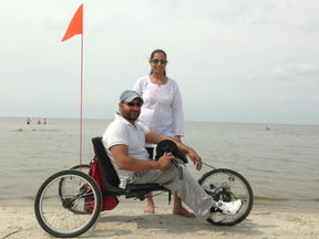 Polio victim Sukhjit Johal and wife Harjit at Grand Beach in 2013 with the custom tricycle that will stolen from their Amber Trails home in Winnipeg on July 20, 2017. A GoFundMe campaign took a mere two hours on Friday, Aug. 4, 2017, to raise the goal of $3,500 for a new custom tricycle for Sukhjit. SUBMITTED PHOTO