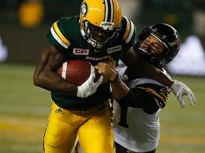 Edmonton Eskimos Chris Edwards (26) breaks away from Hamilton Tiger-Cats Sergio Castillo (41) during second half CFL action on Friday August 4, 2017, in Edmonton.