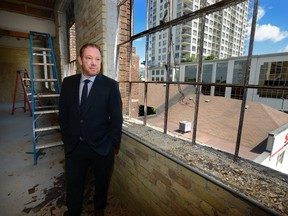 Joel McLean looks out the window at downtown London from the new headquarters of InfoTech at the former Tru Restaurant on Ridout Street. The building when renovated will be home to 400 workers. (MORRIS LAMONT, The London Free Press)