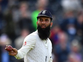 England’s Moeen Ali walks off the pitch with the ball and a stump, as England celebrate winning the fourth Test match against South Africa during at Old Trafford on Aug. 7, 2017. (ANTHONY DEVLIN/AP)