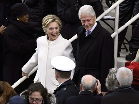 Former Democratic presidential candidate Hillary Clinton and former president Bill Clinton arrive on the platform at the US Capitol in Washington, DC, on January 20, 2017, before the swearing-in ceremony of US President-elect Donald Trump. / AFP / Mark RALSTON (Photo credit should read MARK RALSTON/AFP/Getty Images)