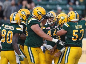 Edmonton Eskimos offensive lineman David Beard, right, celebrates a touchdown with teammates against the Hamilton Tiger-Cats during first half CFL action in Edmonton, Alta., on Friday August 4, 2017.