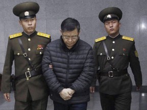 In this Dec. 16, 2015, file photo, Canadian pastor Hyeon Soo Lim, centre, is escorted to his sentencing in Pyongyang, North Korea. THE CANADIAN PRESS/AP/Jon Chol Jin