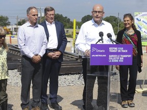 Liberal Transporation Minister Steve Del Duca speaks at a podium at a ceremony to mark the first rail of the Eglinton LRT being put down. (JACK BOLAND, Toronto Sun)