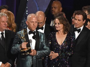 Ryan Murphy and the cast and crew of "The People v. O.J. Simpson: American Crime Story" accept the award for outstanding limited series during the 68th Emmy Awards show on Sept. 18, 2016 at the Microsoft Theatre in downtown Los Angeles. (VALERIE MACON/AFP/Getty Images)