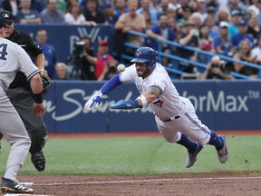 Kevin Pillar of the Toronto Blue Jays dives but is tagged out at home plate by Masahiro Tanaka of the New York Yankees during MLB action at Rogers Centre on Aug. 9, 2017. (Tom Szczerbowski/Getty Images)