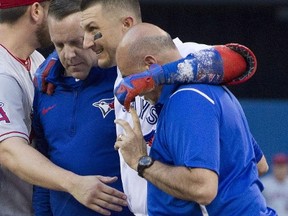 Jays shortstop Troy Tulowitzki (centre) is on the 60-day DL. (The Canadian Press)