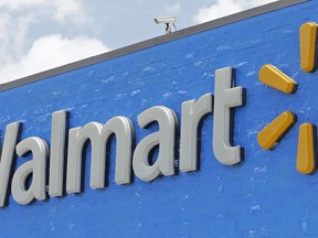 Walmart is apologizing after a photo of a back-to-school store sign placed over a glass firearms display started rocketing across social media on Wednesday. (Alan Diaz/AP Photo/Files)