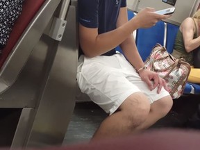 In this screenshot, a woman charged with animal cruelty is seen with her dog on a subway train on August 4, 2017 in Toronto, Ontario. (YouTube/Roxy Huang)