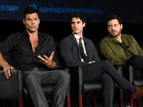 Ricky Martin, left, a cast member in the FX series "The Assassination of Gianni Versace: American Crime Story," answers a reporter's question as fellow cast members Darren Criss, center, and Edgar Martinez look on during the 2017 Television Critics Association Summer Press Tour at 20th Century Fox Studios on Wednesday, Aug. 9, 2017, in Los Angeles. (Photo by Chris Pizzello/Invision/AP)