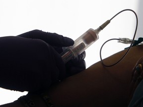 In this April 28, 2015 file photo, a patient has her blood drawn for a liquid biopsy during an appointment at a hospital in Philadelphia. Scientists have the first major evidence that such blood tests hold promise for screening people for cancer. Hong Kong doctors tried it for a type of head and neck cancer, and boosted early detection and one measure of survival. Results were published Wednesday, Aug. 9, 2017 in the New England Journal of Medicine. (AP Photo/Jacqueline Larma, File)