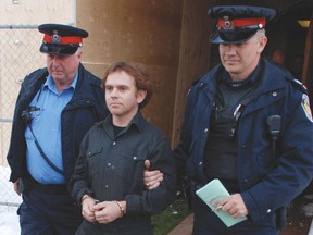 Police lead John Douglas Robinson, 42, out of the Woodstock courthouse after his appearance in 2012. (File photo)