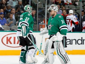 Dallas Stars' Kari Lehtonen and Antti Niemi of Finland tap pads as Lehtonen is replaced by Niemi during NHL action against the Ottawa Senators in Dallas on March 8, 2017. (AP Photo/Tony Gutierrez)