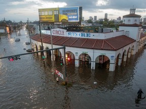 This Saturday, Aug. 5, 2017, file photo shows the Circle Food Store engulfed in floodwaters in New Orleans. With more rain in the forecast and city water pumps malfunctioning after weekend floods, New Orleans' mayor is urging residents of some waterlogged neighborhoods to move their vehicles to higher ground. Mayor Mitch Landrieu's office said early Thursday, Aug. 10, 2017, the city has lost service to one of its power turbines, which powers most of the pumping stations service the East Bank of New Orleans. (Brett Duke/NOLA.com The Times-Picayune via AP)