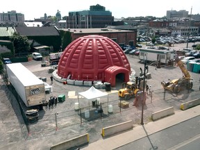 Workers set up the inflatable igloo that houses the cinema where SESQUI's Horizon 360 movie is to be presented between Friday and Tuesday in Kingston. 
Elliot Ferguson/The Whig-Standard