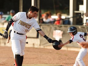 Edmonton Prospects Michael Gahan (13) celebrates a run during a Western Major Baseball League playoff game versus the Medicine Hat Mavericks at RE/MAX Field in Edmonton on Wednesday, August 9, 2017.