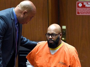 In this March 9, 2015, file photo, defence attorney Mathew Fletcher, left, talks with his client, Marion "Suge" Knight upon his arrival in court for a hearing about evidence in his murder case in Los Angeles.  (AP Photo/Kevork Djansezian, Pool, File)