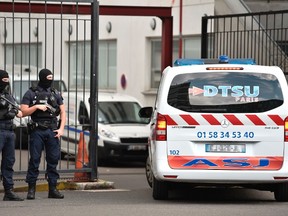 An ambulance enters as French special police officers stand guard at the entrance of the Georges Pompidou Hospital in Paris, on August 11, 2017, where the suspect in the attack of Levallois-Perret was transferred and hospitalized. (STEPHANE DE SAKUTIN/Getty Images)